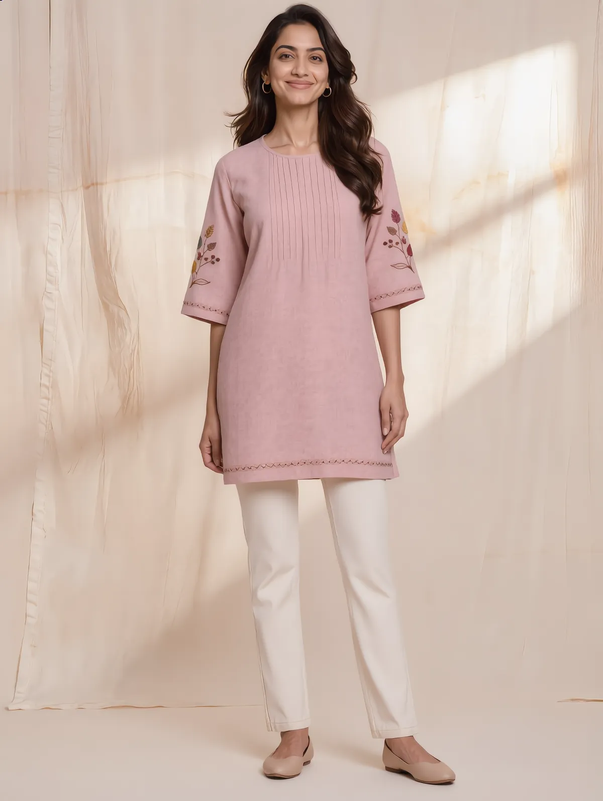 Blush linen tunic with front pintucks and leaf embroidery on the sleeves
